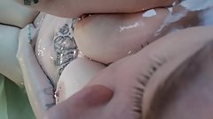 Chubby tattooed girl playing in the bath