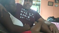 Man rubbing woman's legs while sitting in the couch.